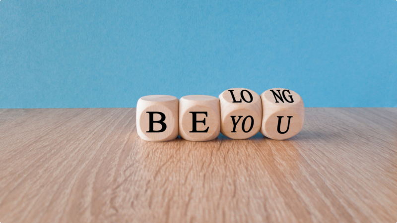 Dice with the saying Be You but also spelling Belong