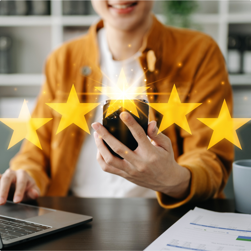 Person on their phone with a graphic overlay showing 5 stars.