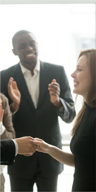 Business people celebrating success with applause and handshakes.