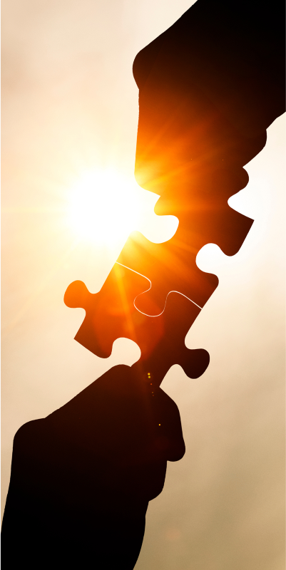Two Hands Holding a Piece of Jigsaw Puzzle, Symbolizing Teamwork and Collaboration.