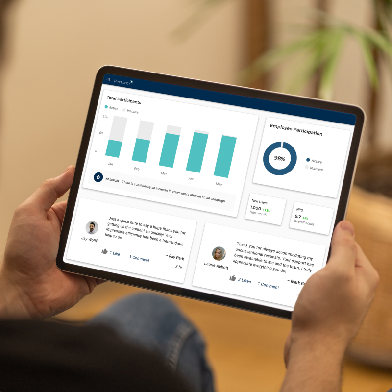 Male holding tablet showing digital dashboard of PerformX.