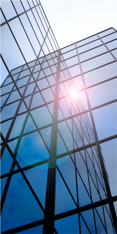 A modern building with sleek glass windows, offering a clear view of its interior and exterior.