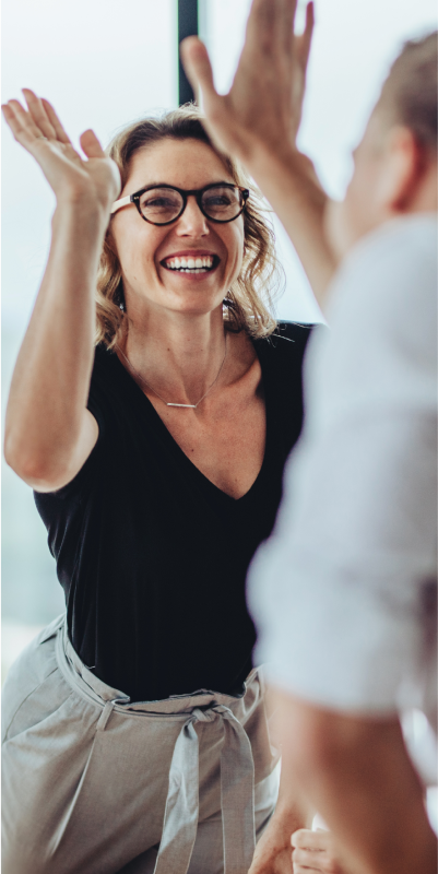 A woman giving a high five to a fellow colleague